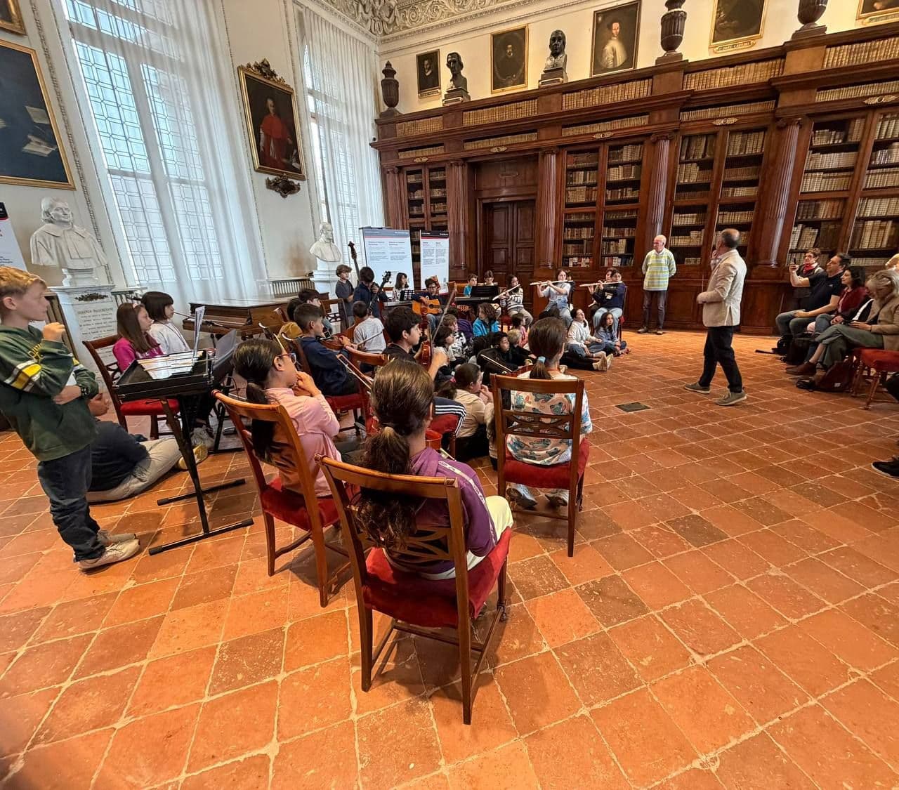 Alunni dell'Istituto comprensivo Virginio Muzio impegnati in un'esecuzione musicale nel Salone Furietti della Biblioteca Civica Angelo Mai di Bergamo.